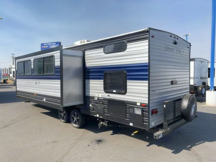 This grey and blue Grey Wolf travel trailer with its slide-out extended is ready for your RV rental adventure. Great for camping!. Forest River Cherokee Grey Wolf 2021