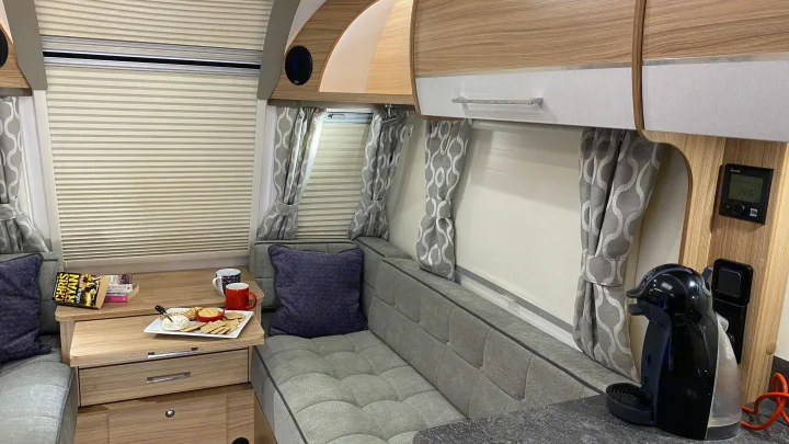 This RV rental offers a well-appointed interior with comfortable seating, cabinetry, window blinds, and a convenient coffee maker.. Bailey Pheonix 640 2022