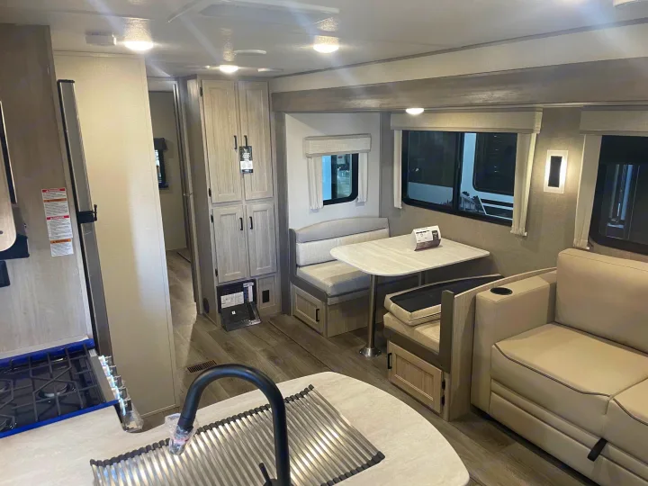 Modern RV rental interior showing a functional kitchen, comfy dinette, and relaxing sofa seating.. Coachman Catalina, Legacy edition 343BHTS 2024