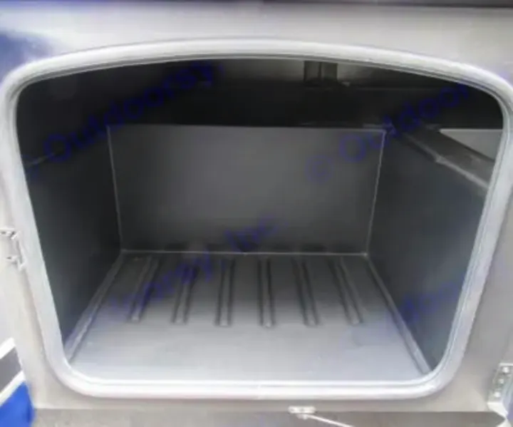RV rental: Empty side storage compartment on an RV, showing its deep interior and ridged floor.. Thor Miramar 2022