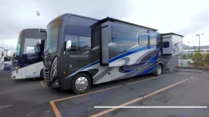 Miramar Class A RV rental, dark with blue/silver graphics, parked with slide-outs extended. Ready for adventure!. Thor Miramar 2022