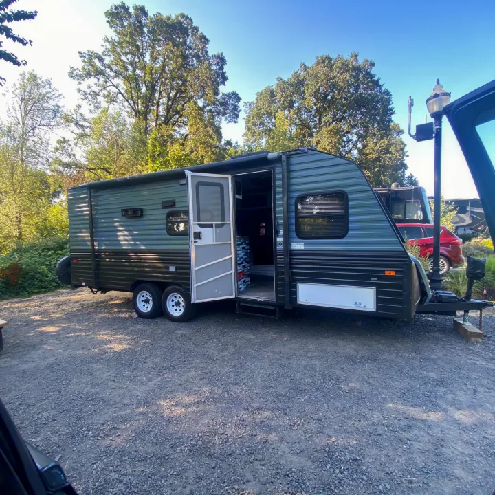 Green travel trailer RV with open. Fleetwood Prowler 1996