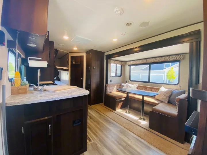 Inside this modern RV rental: a bright kitchen area, comfy dinette, and spacious living. Ideal for your next journey.. Jayco Jay Flight SLX 2018