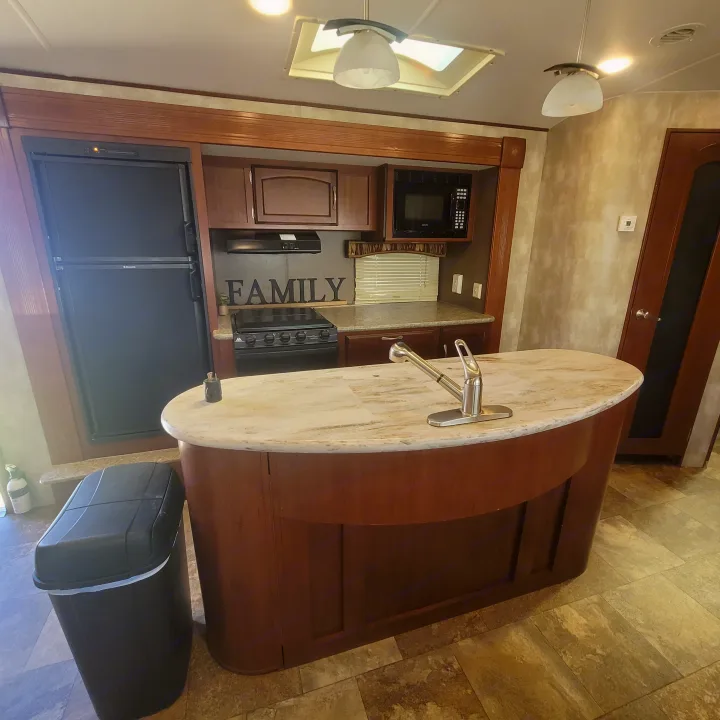 RV rental: Equipped kitchen with refrigerator, stove, microwave, and a central island with sink. Perfect for trips.. Winnebago Ultralite 2014