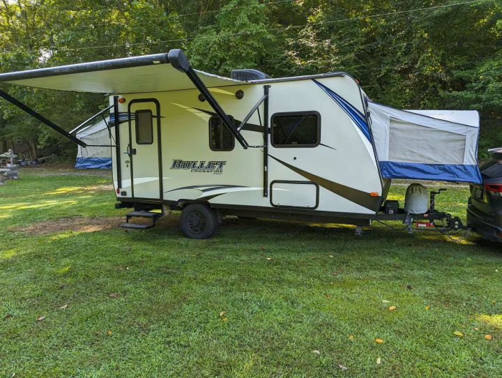 Spacious Bullet Crossfire travel trailer (RV rental) set up with awning extended, perfect for camping leisure.. Keystone RV Bullet Crossfire 2018