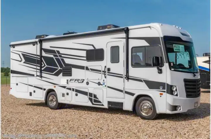 Modern white FR3 RV rental motorhome with bold black graphics, parked on gravel. Ideal for your next travel adventure.. FR3 32DS 2024