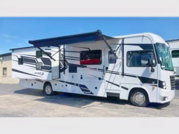 This spacious white motorhome with a black awning is perfect for your next rv rental adventure.. FR3 32DS 2024