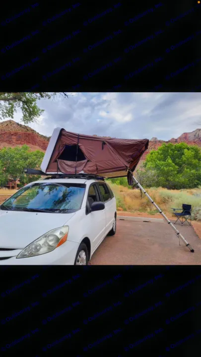 Minivan RV rental with rooftop tent and ladder set up for camping in a scenic, mountainous landscape.. Other Other 2009