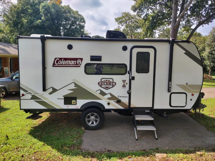 This rv rental, a white Coleman Rubicon Edition travel trailer, is parked and ready for adventure.. Dutchmen Coleman Rubicon 2021