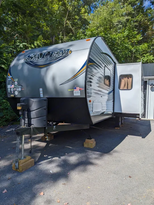 A spacious Salem travel trailer, often available as an rv rental, is parked outdoors, slide-out extended, for camping.. Forest River Salem 2017