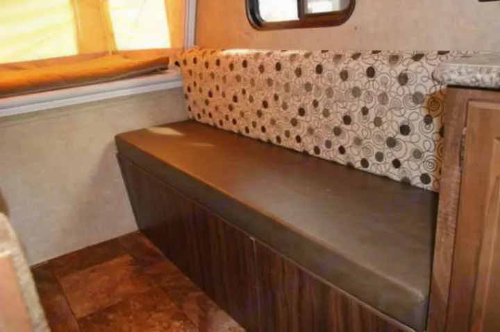RV rental's inviting seating area: brown bench with patterned cushions and warm wood flooring.. Clipper Clipper Trailer 2016