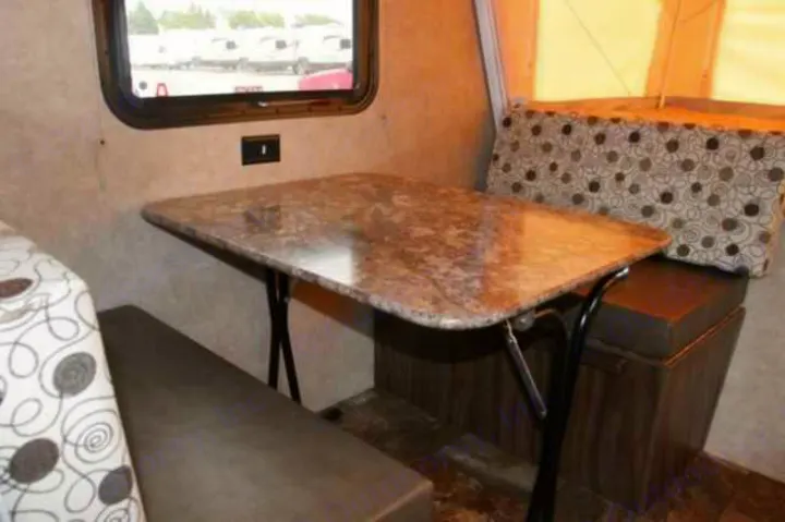 RV rental dinette interior: a compact table with granite-look top and two upholstered benches, perfect for travelers.. Clipper Clipper Trailer 2016