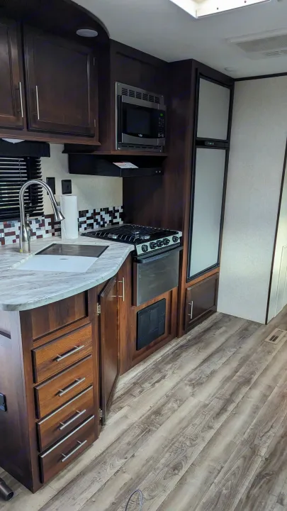 This fully equipped RV rental kitchen features a stove, microwave, fridge, and ample storage for your road trip comfort.. Jayco Jay Flight 2019