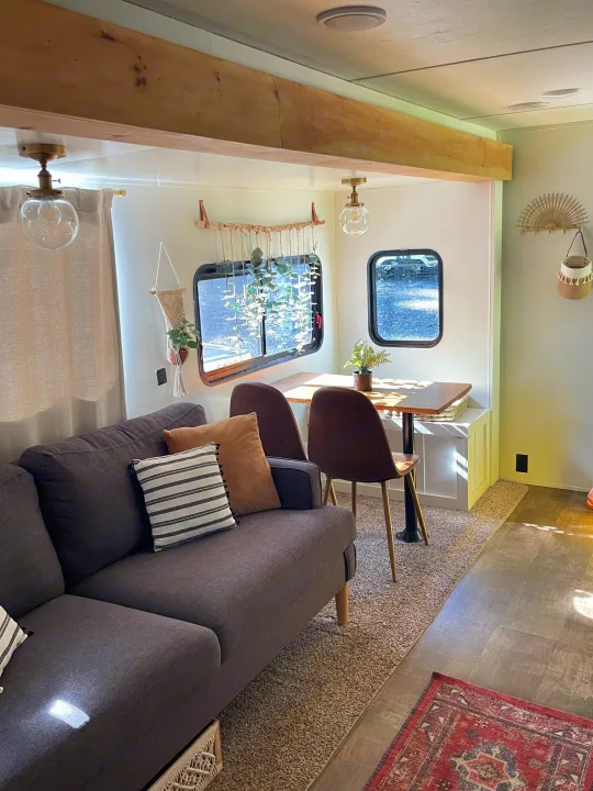 Modern RV rental interior with a cozy sofa, dining area, and stylish decor. Bright and inviting living space.. Crossroads RV Zinger 2017