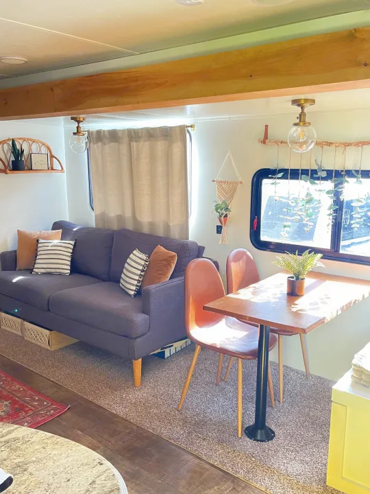 Bright RV rental interior: modern living space with comfy sofa, dining area, and thoughtful, inviting decor.. Crossroads RV Zinger 2017