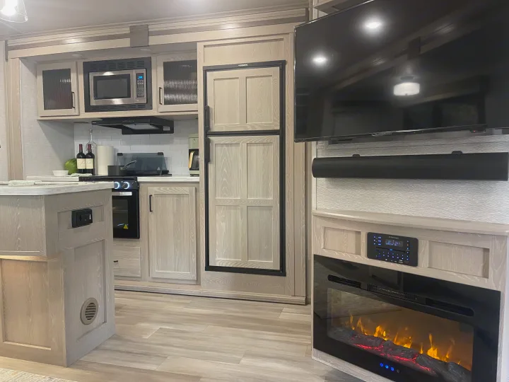 Modern RV rental interior with full kitchen, entertainment, and cozy fireplace. Perfect for your next trip!. Forest River Flagstaff Classic 2022