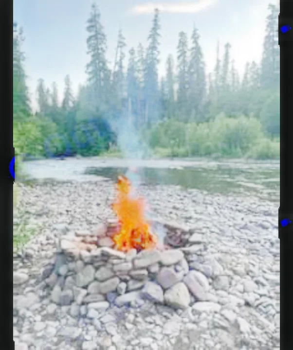 A cozy campfire crackles on a rocky riverbank, perfect for your RV rental adventure. Enjoy nature & outdoor camping by the water.. Winnebago Minnie Winnie 2020