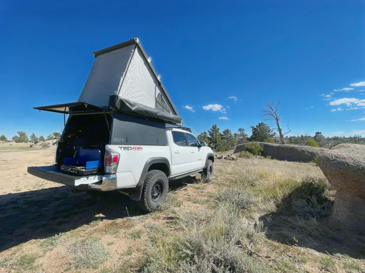 White Toyota Tacoma with GFC truck camper, ready for adventure! Ideal for your next RV rental or overlanding trip.. 2023