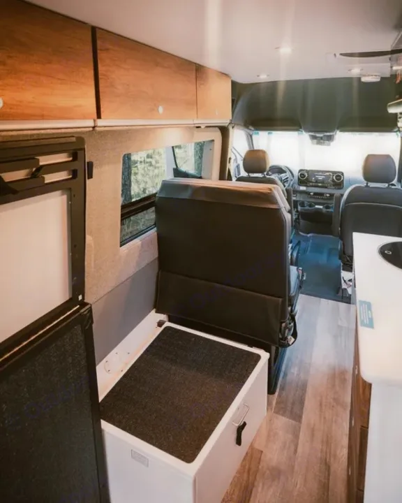 Explore this well-appointed rv rental camper van. Interior features cabinets, convertible seating, and a compact kitchen.. Storyteller Overland Storyteller Overland Class B 2022
