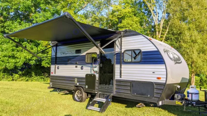 This Wolf Pup travel trailer RV rental, with its awning extended, is ready for a camping adventure.. Cherokee wolf pup 2021