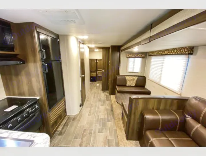 Modern RV rental interior: kitchen, dinette, and living room setup. Perfect for your next adventure.. Keystone RV Bullet Ultra Lite 2018