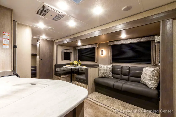 Spacious RV rental interior featuring a cozy living area, dinette, kitchen, and bunk beds. Ideal for family adventures.. Coachmen Catalina 2022