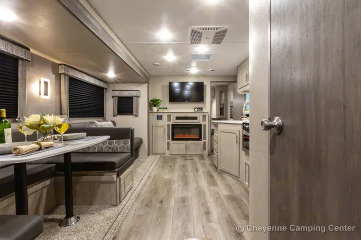 Relax in this well-appointed RV rental's living area, complete with a dinette, TV, and electric fireplace.. Coachmen Catalina 2022