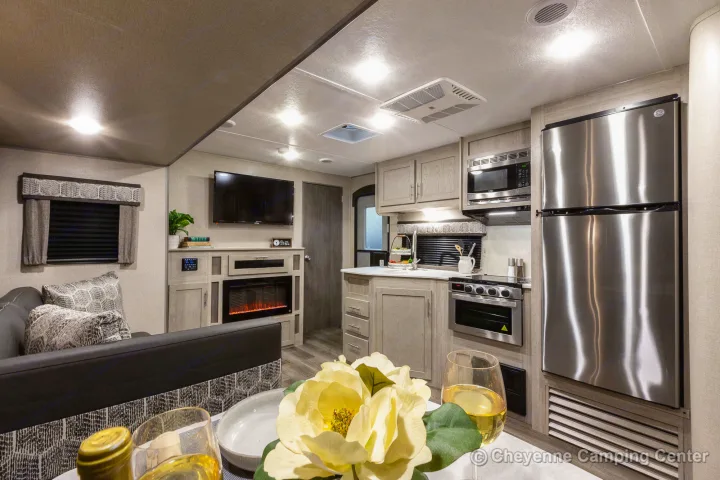 This RV rental interior showcases a modern living area, full kitchen, and dining space, ideal for comfortable travel.. Coachmen Catalina 2022