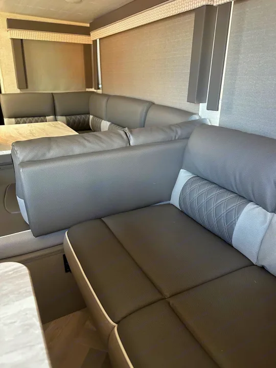 Modern grey U-shaped dinette in an RV rental. Cozy interior seating with quilted accents.. Forest River Salem Cruise Lite 2021