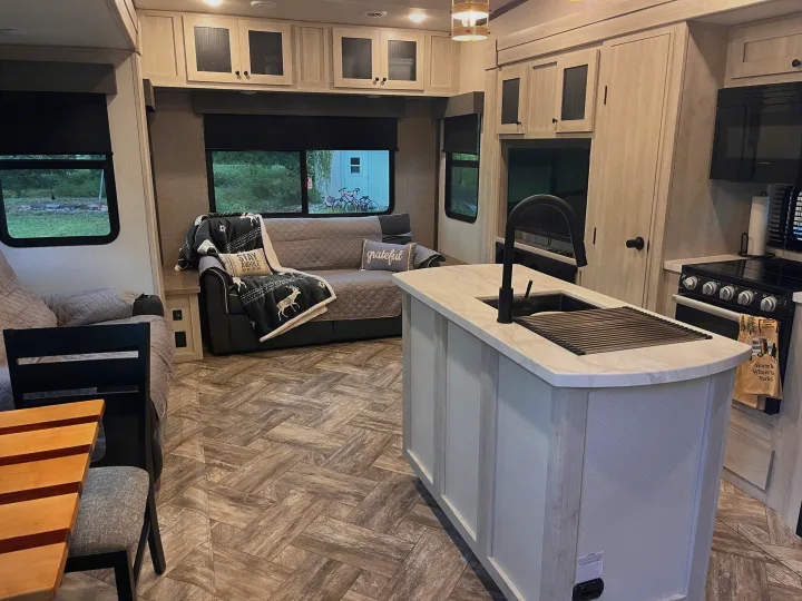 Spacious RV rental interior with modern kitchen, comfortable living area, and dinette. Ready for your next camping trip!. Forest River Wildcat 2023