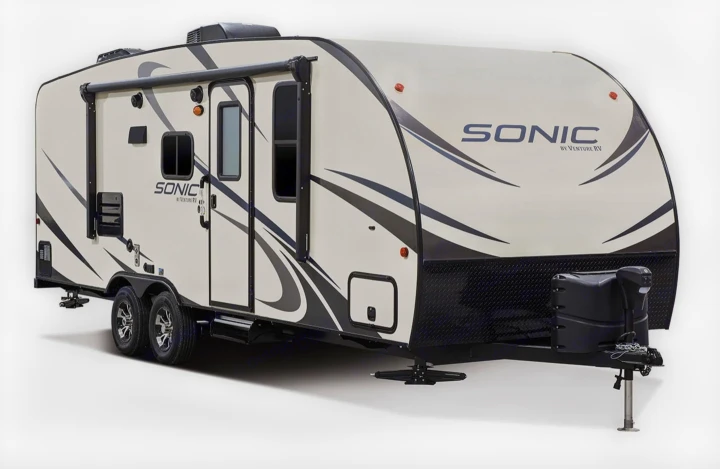 A white Sonic travel trailer, perfect for an RV rental, with a black awning, dual axles, and front hitch.. Sonic Sonic Trailer 2019