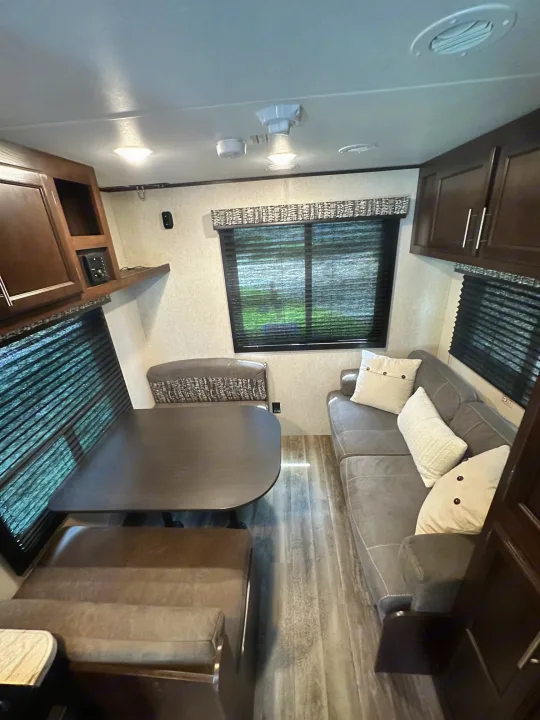 RV rental interior: comfy sofa, dinette with seating, and wood-look floors create a welcoming living space.. Jayco Jay Flight SLX 2020
