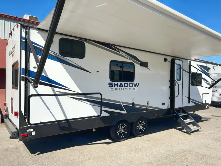 White Shadow Cruiser travel trailer with extended awning. A perfect rv rental for adventures, featuring handy steps.. Cruiser Rv Corp Shadow Cruiser 259BHS 2021