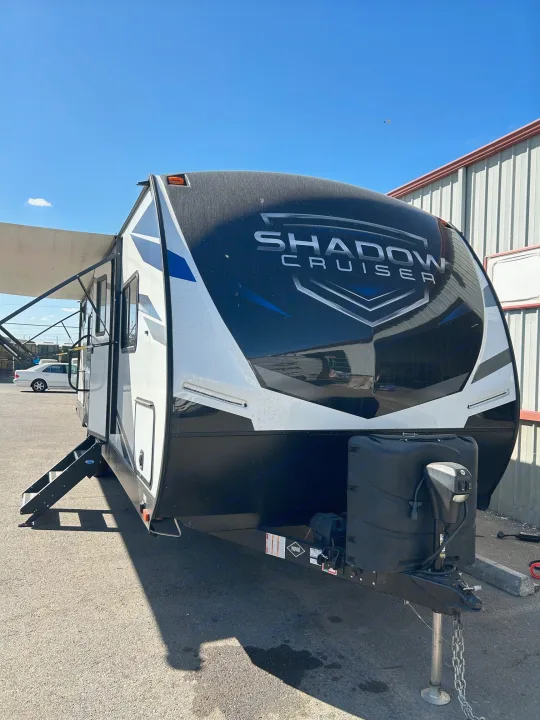 This black and white Shadow Cruiser travel trailer, ideal for RV rental, is parked outdoors with awning and steps extended.. Cruiser Rv Corp Shadow Cruiser 259BHS 2021