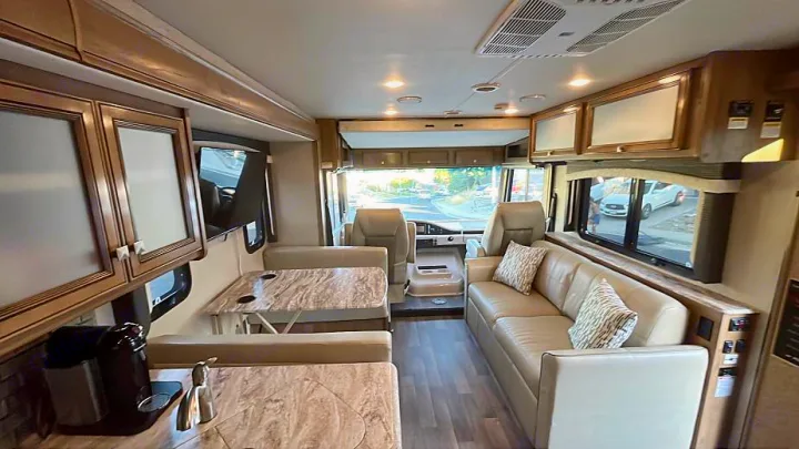 Spacious RV rental interior featuring a comfortable living area, dinette, kitchen space, and front cockpit, perfect for travel.. Flair-Fleetwood Flair-Fleetwood Motorhome 2020