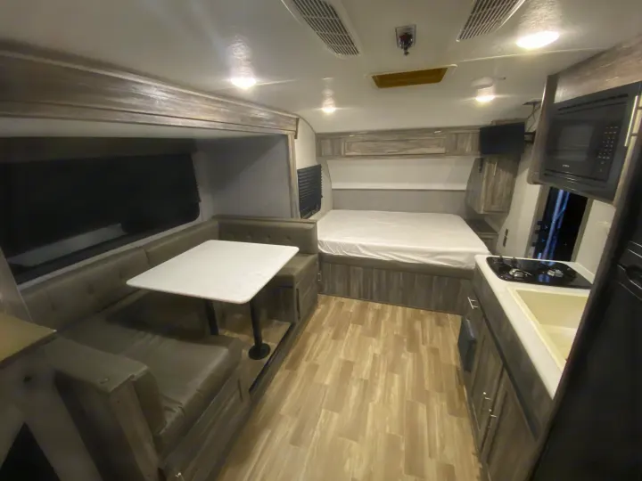 Spacious RV rental interior featuring a dinette, bed, and fully equipped kitchen.. Forest River Salem FSX 2020