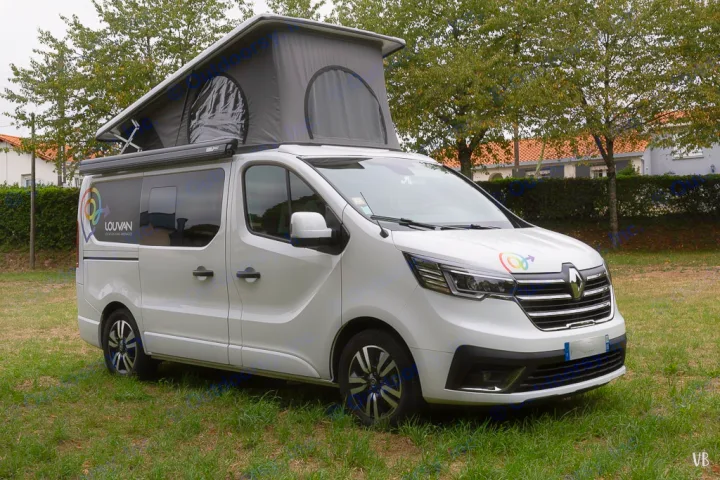 White pop-top camper van for rv rental, showing colorful branding on side & front, parked on green grass.. HANROAD TREK 4 2024