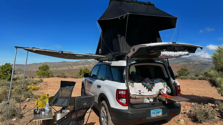RV rental adventure: Ford Bronco Sport with rooftop tent, awning, and full camp setup in a stunning desert landscape.. Ford Bronco Sport 2022