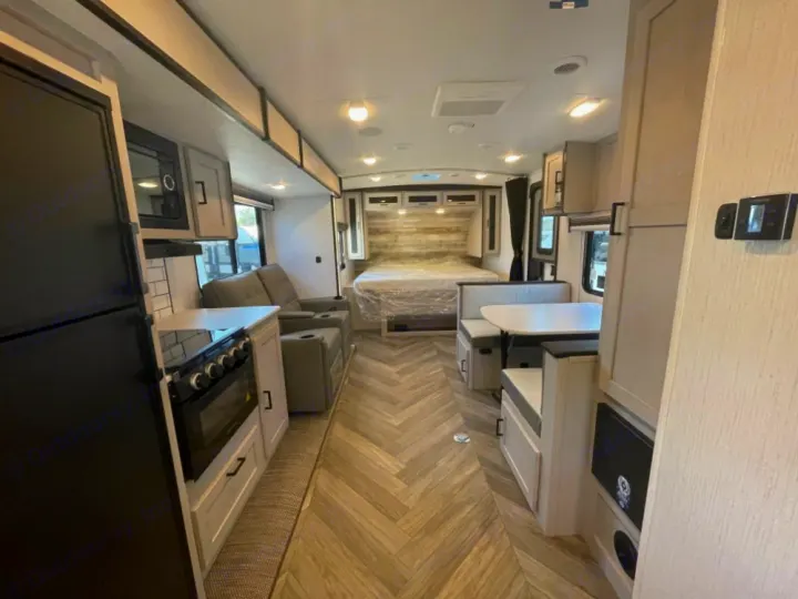 Spacious RV rental interior featuring a modern kitchen, cozy dinette, comfortable living area, and bed.. Heartland RVs Mallard 2023