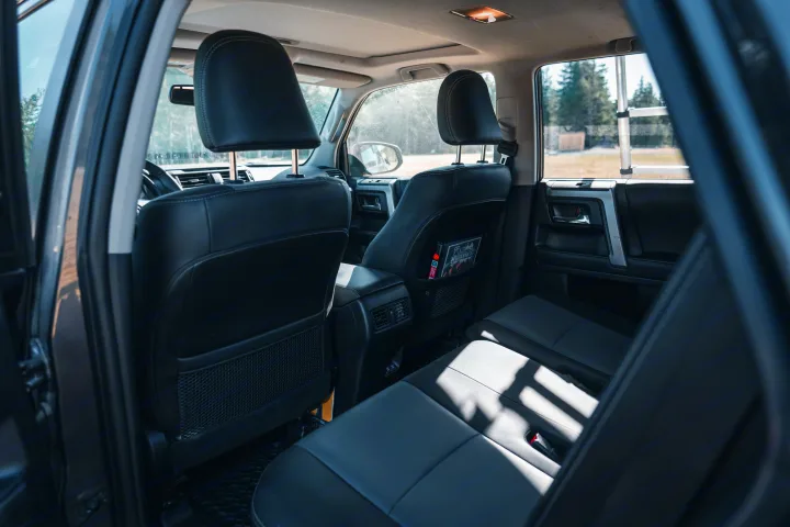Spacious and clean SUV interior with black seating, visible front cabin, and exterior rack support. Perfect for your next rv rental trip.. Toyota 4Runner 2021