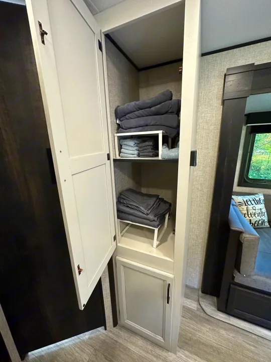 Neatly organized RV rental closet with folded blankets & towels, perfect for your adventure needs. Efficient RV storage.. Jayco Jay Flight SLX 2022
