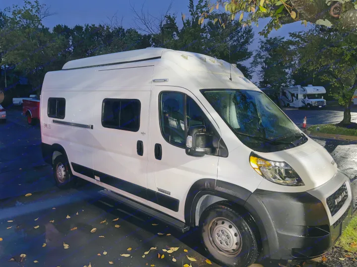 White Winnebago Solis camper van, ideal for your next RV rental adventure, parked at night.. Winnebago Solis 2023