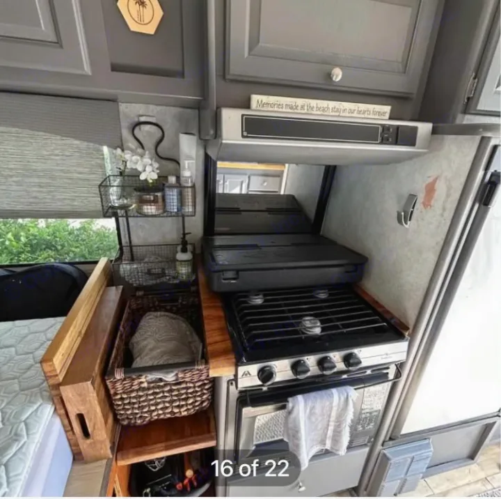 Compact RV rental kitchen features stove, oven, and organized storage for easy living on the go.. Ford Econoline 2004
