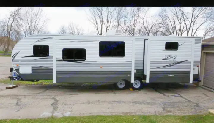 A spacious white & gray Z-1 travel trailer (RV) with slide-outs, ideal for your next rv rental camping trip.. Crossroads RV Z-1 2016