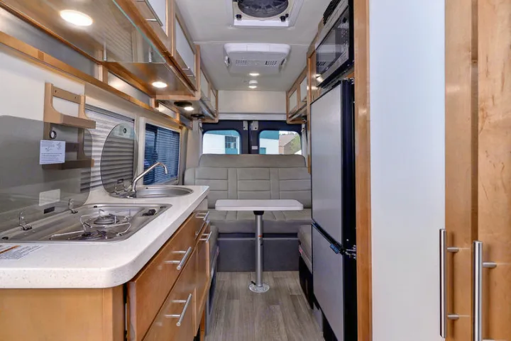 Explore this RV rental's efficient interior: compact kitchen, dining area, and clever storage for road trips.. Coachmen CrossFit 22c 2019