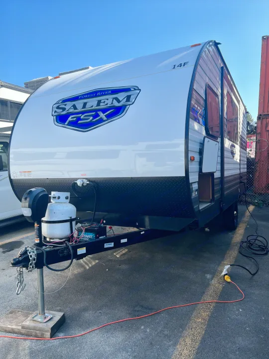 Forest River Salem FSX travel trailer RV rental, detailed view of front, hitch, propane tank, battery, and power cords.. Forest River Salem Cruise Lite 2024