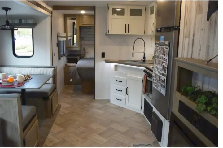 Spacious RV rental interior with a well-appointed kitchen, comfortable dinette, and a glimpse of the cozy sleeping area.. Puma Palomino 2021