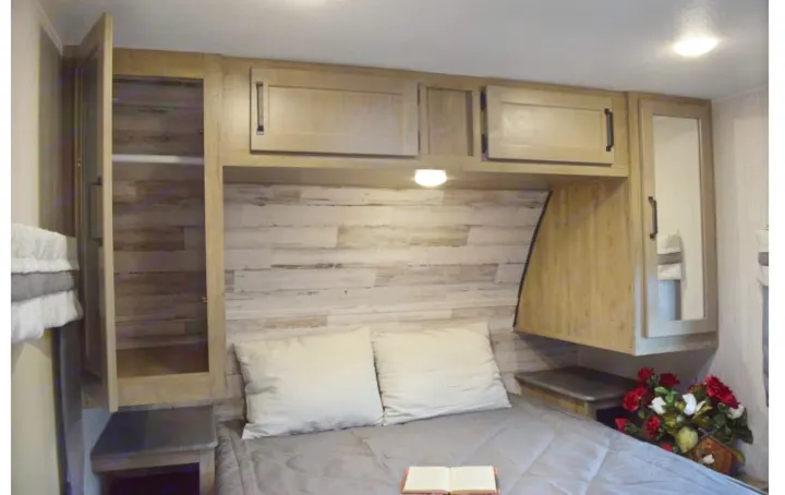 Cozy RV rental bedroom with spacious storage: cabinets, open closet, nightstands, and comfy bed for your travels.. Puma Palomino 2021