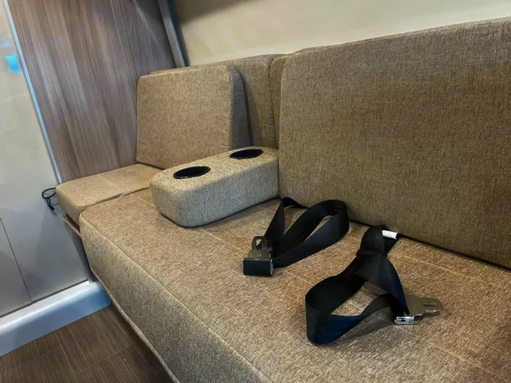 RV rental interior features comfortable bench seating, cupholders, and seatbelts, ready for safe travels.. Ram Thor Sequence 2021