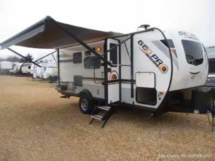 A white and gray Geo Pro travel trailer with an extended awning and entry steps, ready for your next RV rental.. Forest River Rockwood Geo Pro 2022